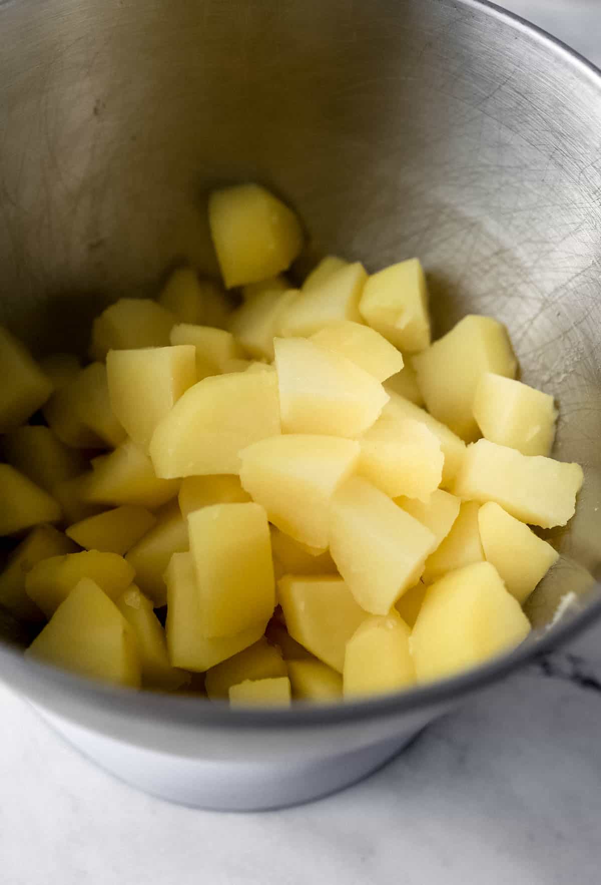 Cooked potatoes added to stand mixer bowl. 