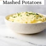 Close up side view of potatoes in a bowl pin with title text overlay.