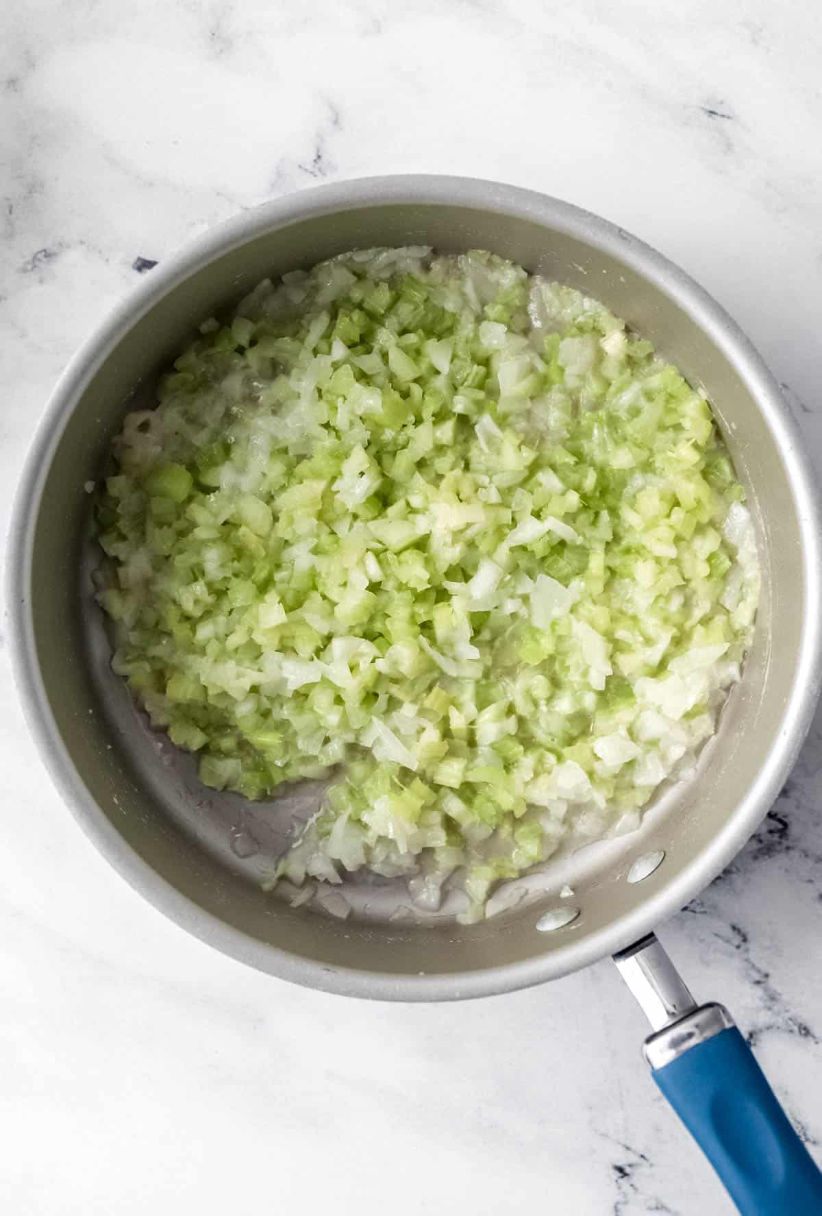 Chopped celery, onion, and melted butter in large skillet 