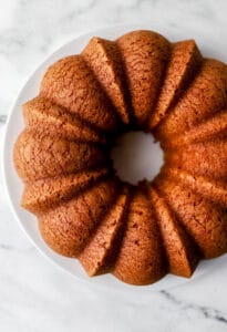 Overhead view of rum cake on white plate.