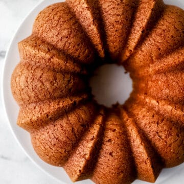 Overhead view of rum cake on white plate.