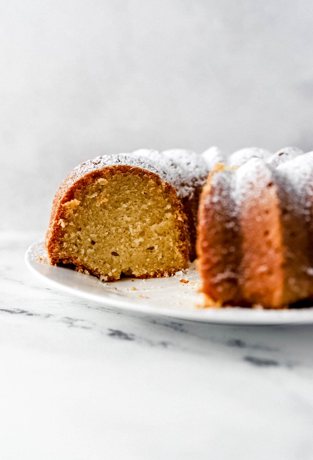 rum cake simply lakita 3 Close up side view of cake with a piece cut out of it.