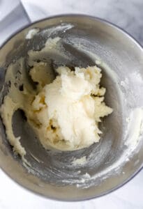 Butter and sugar combined in stand mixer bowl.