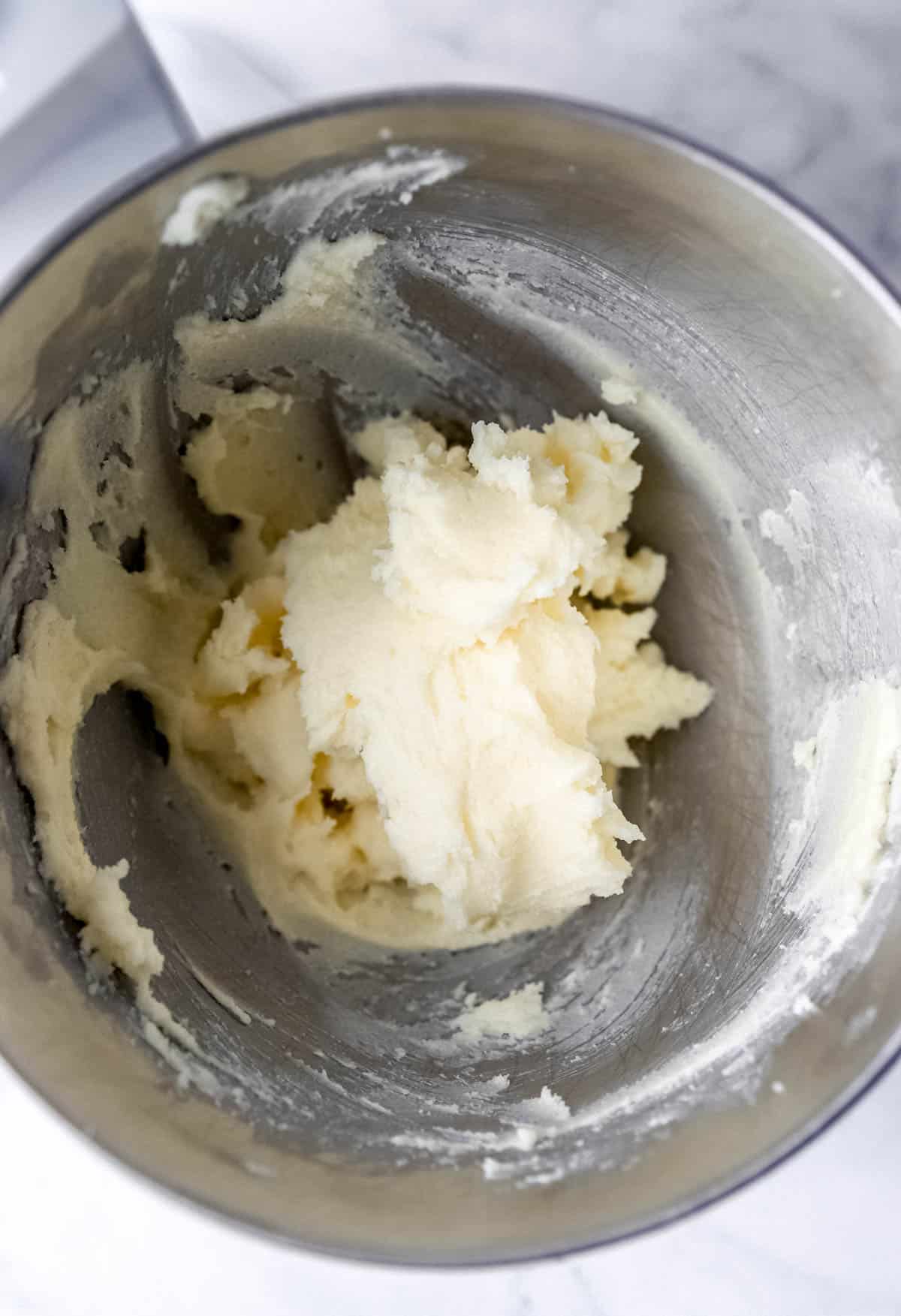 Butter and sugar combined in stand mixer bowl. 