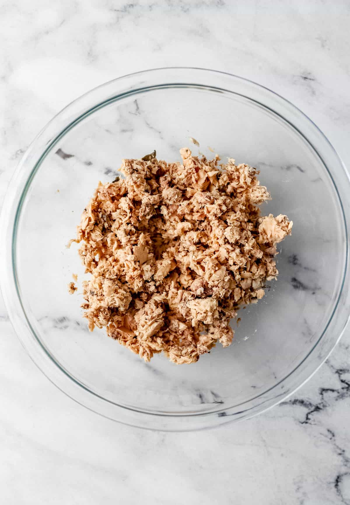 Canned salmon in large glass bowl. 