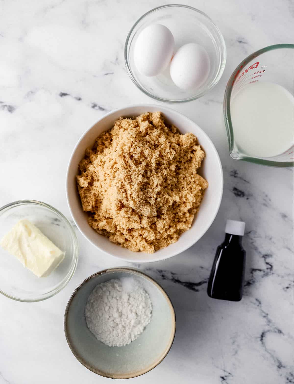 Overhead view of ingredients needed to make pie in separate bowls and containers. 