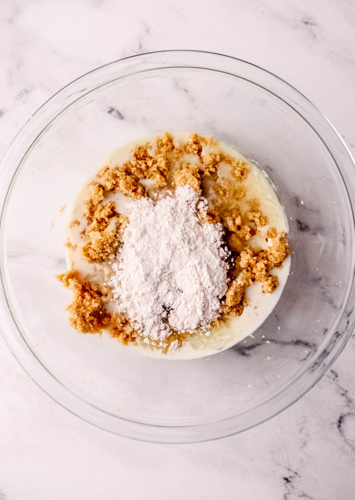 All ingredients to make pie added to large glass mixing bowl. 