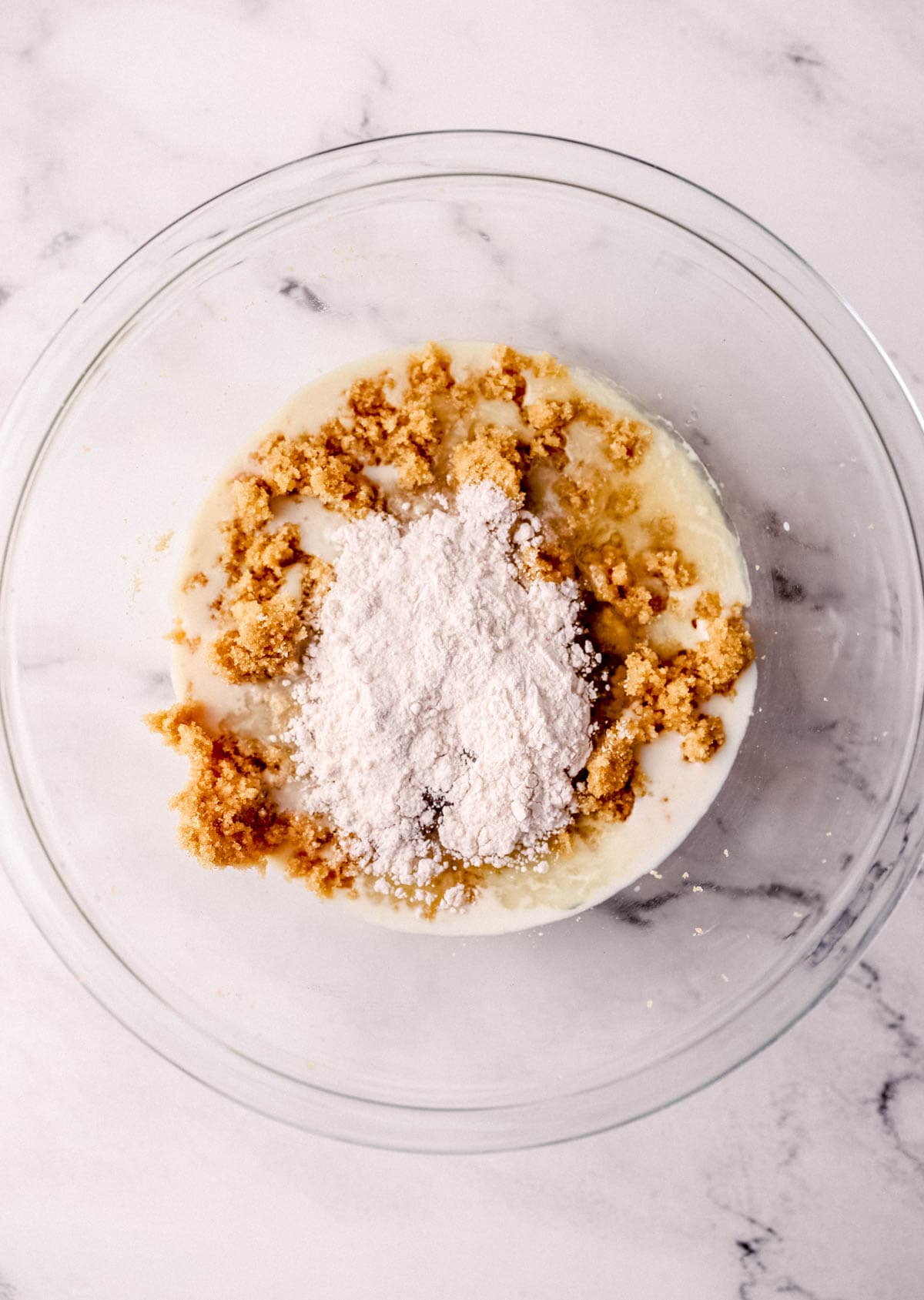 All ingredients to make pie added to large glass mixing bowl. 