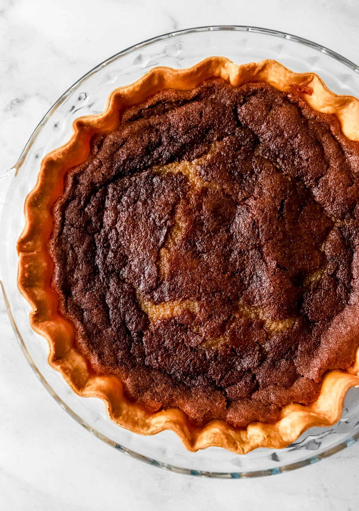 Overhead view of baked pie in glass pie plate. 