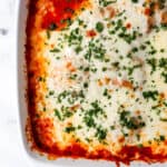 Close up overhead view of chicken bake in baking dish topped with parsley.