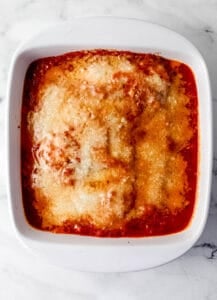 Baked chicken mozzarella in baking dish.