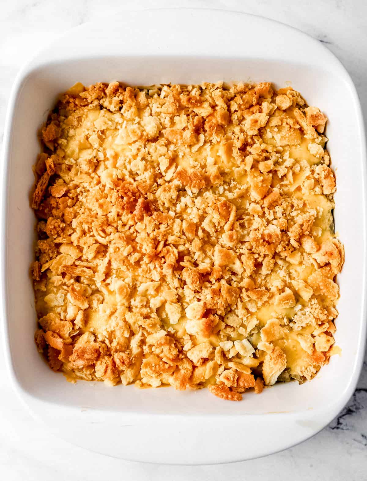 Overhead view of casserole after baking in square white baking dish. 