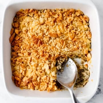 Overhead view of finished casserole with serving spoon in it.