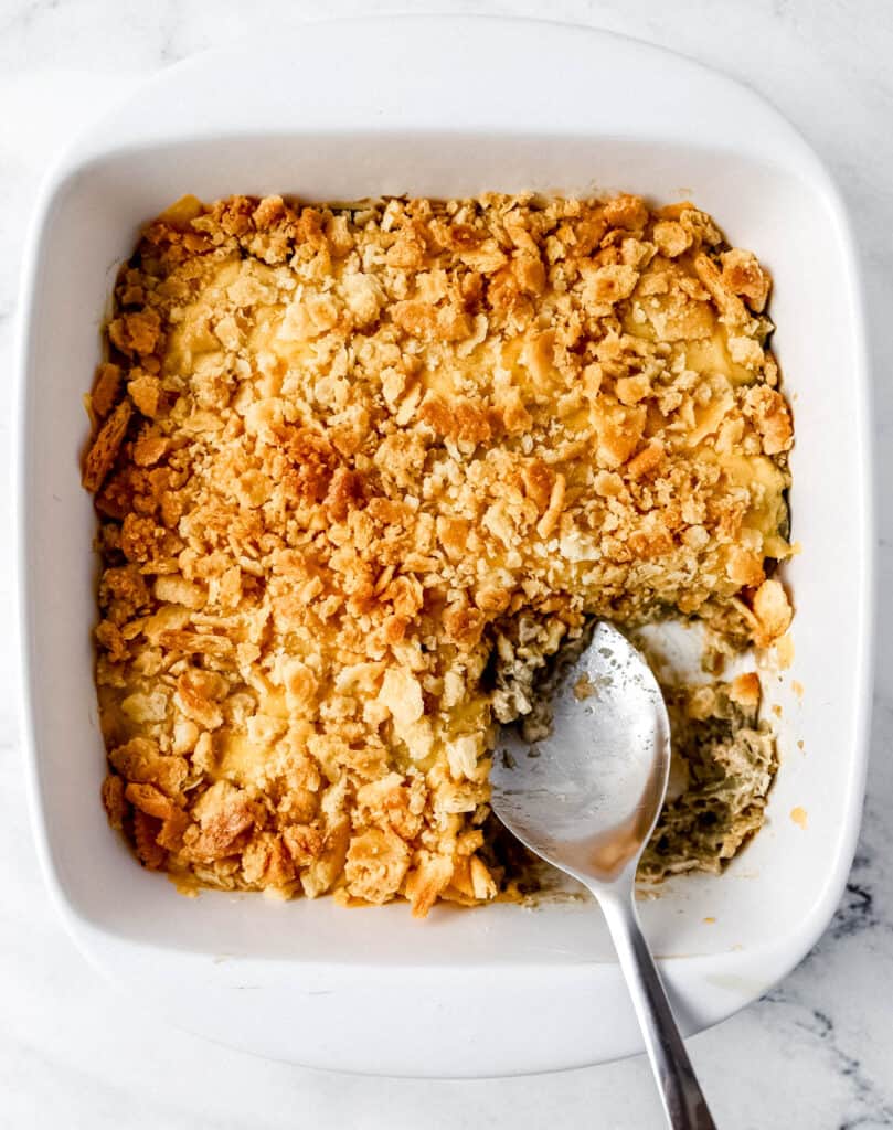 Overhead view of finished casserole with serving spoon in it.