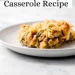 Close up side view of plate of finished casserole on white plate pin with text overlay.