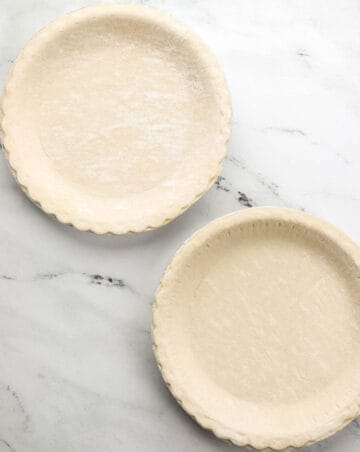 Overhead view of 2 frozen pie crusts.
