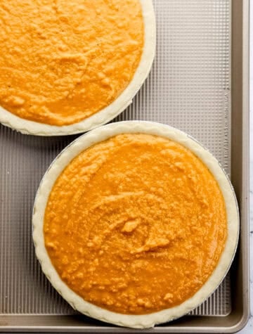 Two unbaked pies on sheet pan.