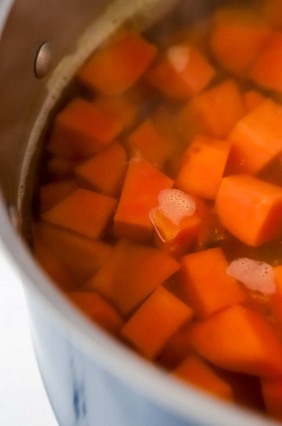 Cooked and cubed sweet potato in a large pot with water. 