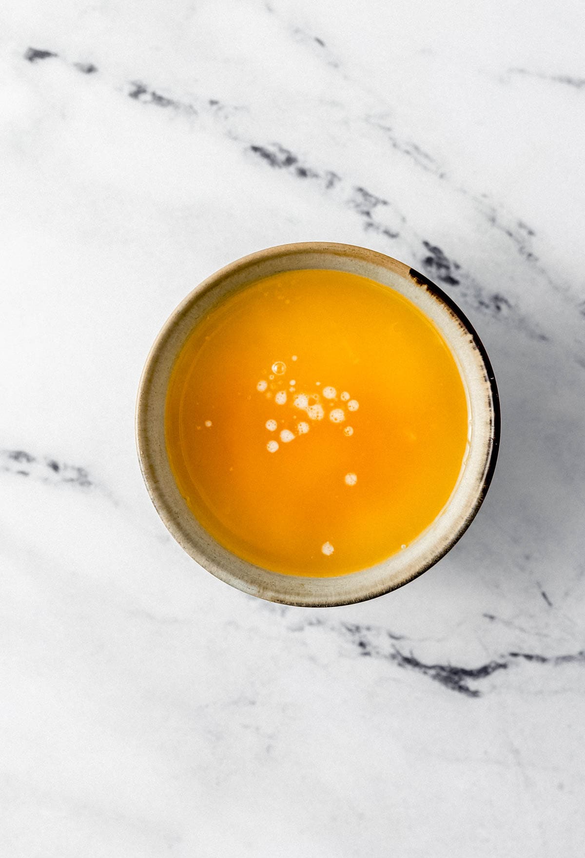 Melted butter, orange juice, and orange juice combined in small bowl. 