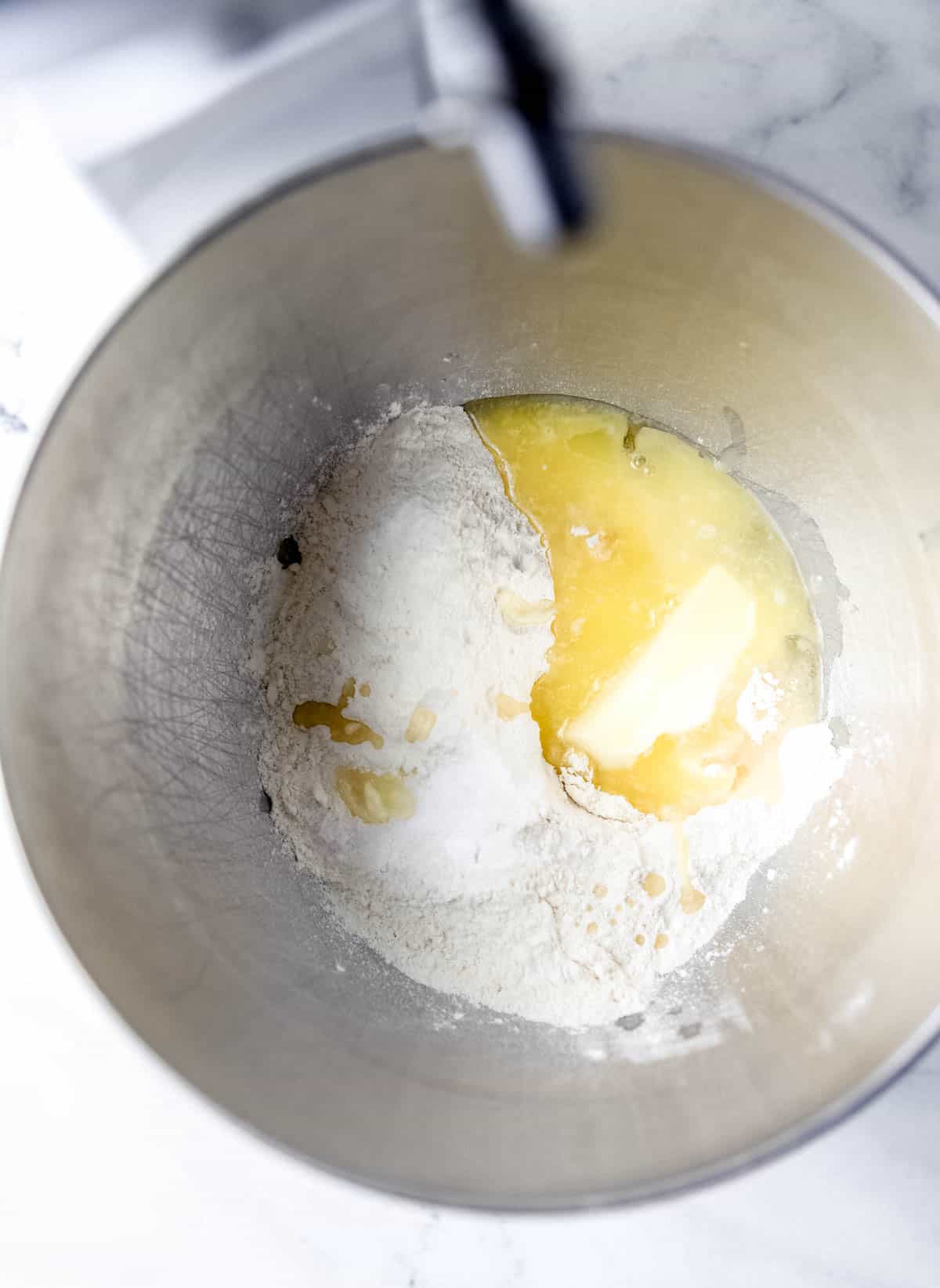 Butter, flour, salt, sugar, egg, and yeast mixture added to stand mixer bowl. 