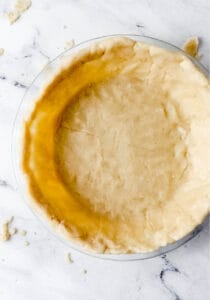 Pie crust added to glass pie plate.
