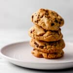 Cookies stacked on top on each other on white plate.