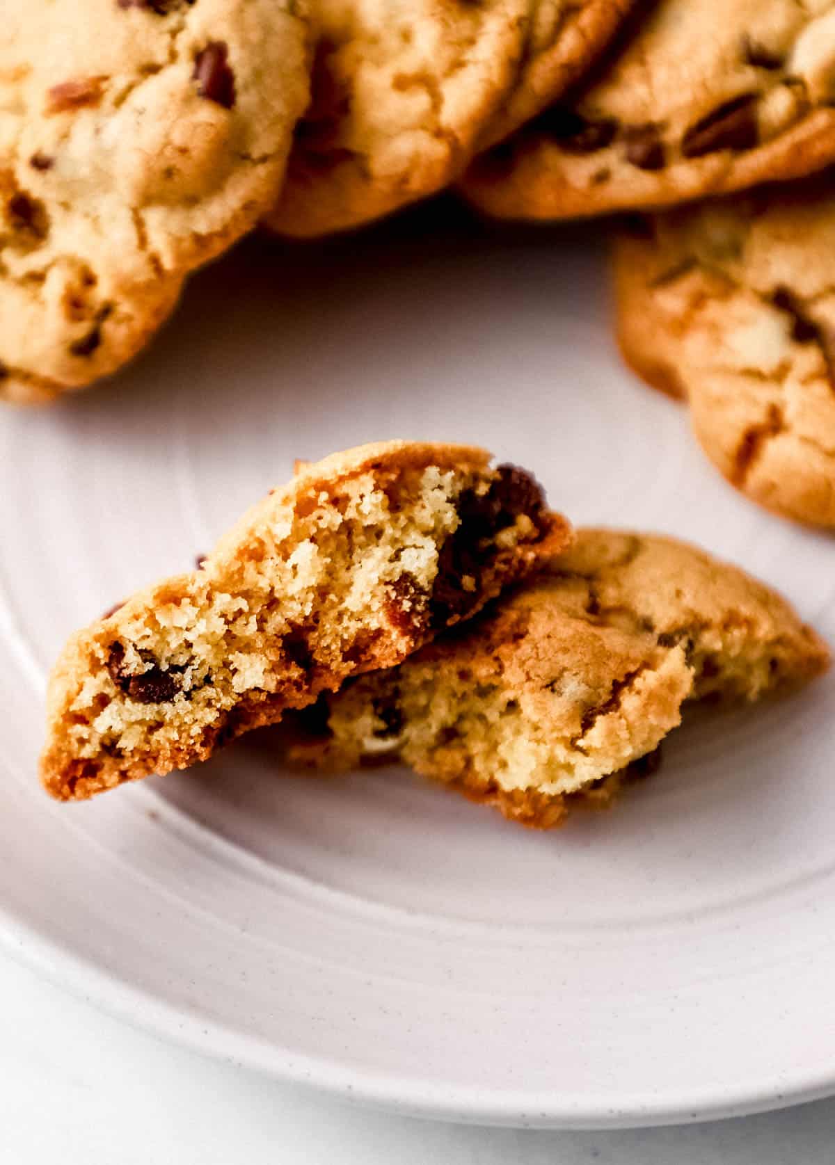 Cookies on white plate with one cookie broke in half. 