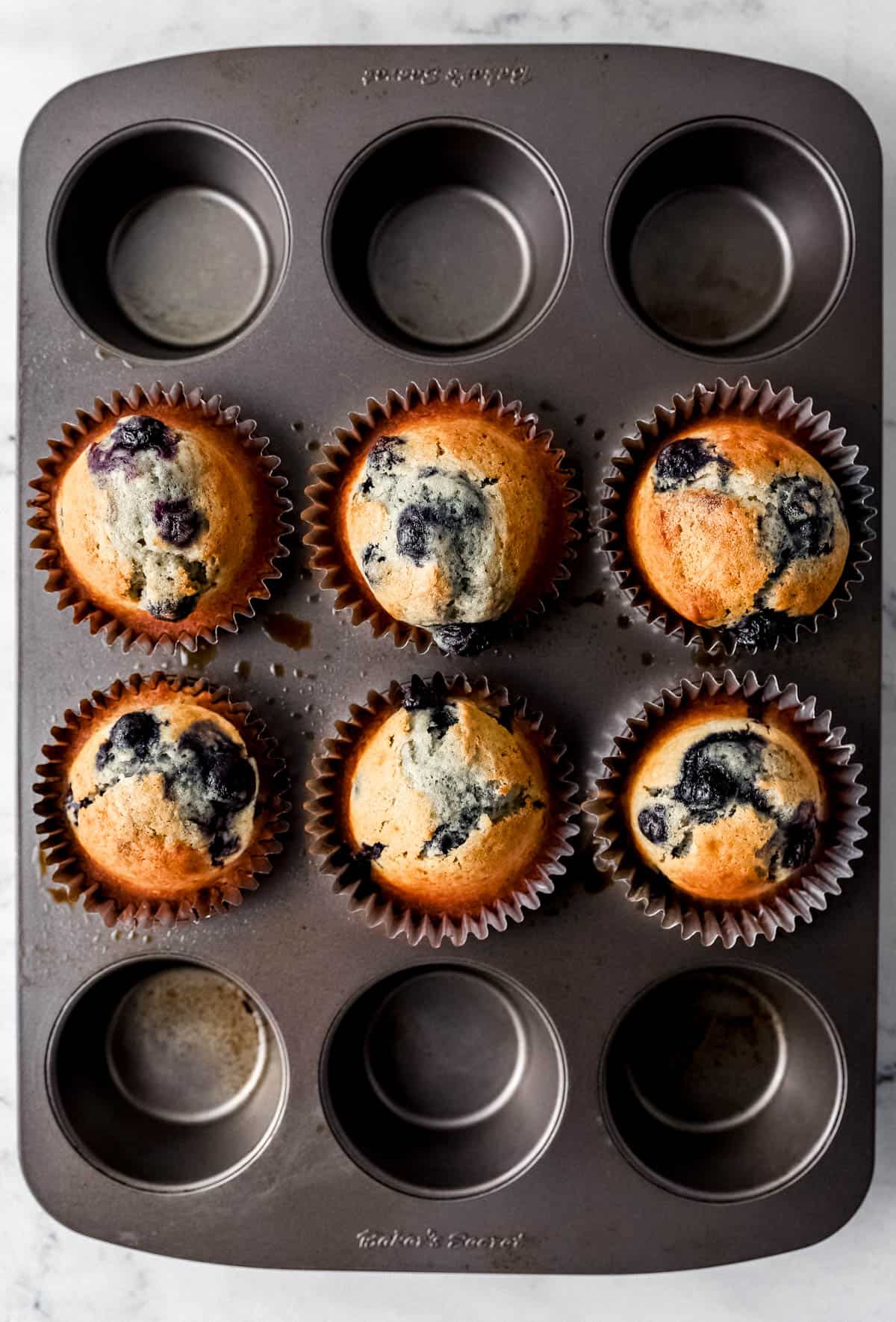 Overhead view of muffin in pan after baking. 