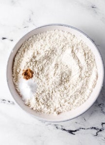 Dry ingredients combined in white bowl.
