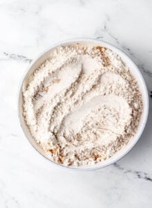 Dry cake ingredients in white bowl.