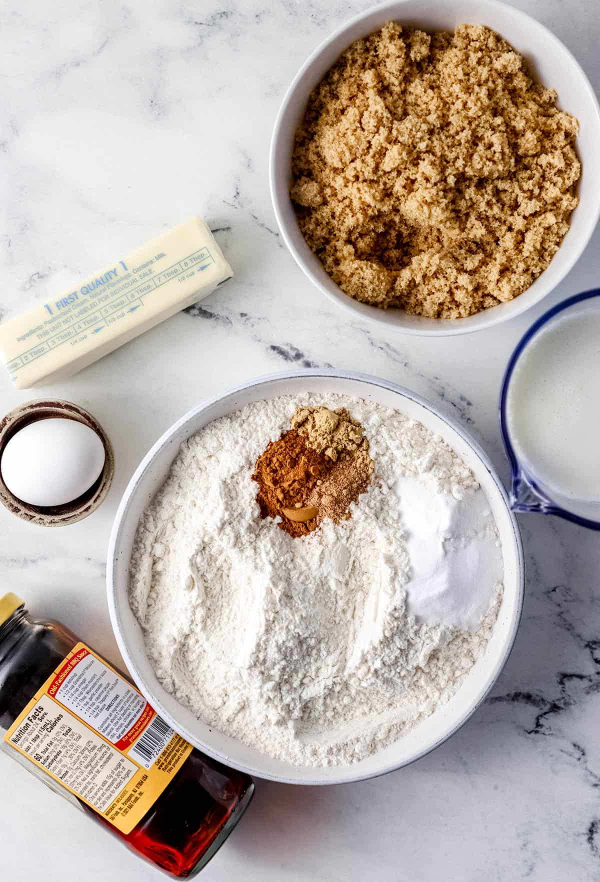 Overhead view of ingredients needed to make muffins in separate containers. 