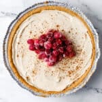 Overhead view of finished eggnog cheesecake topped with cranberries.