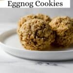 Close up side view of eggnog cookies on white plate pin with text overlay.