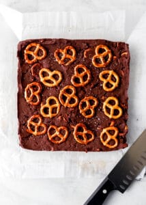 Finished fudge on parchment paper by a knife.