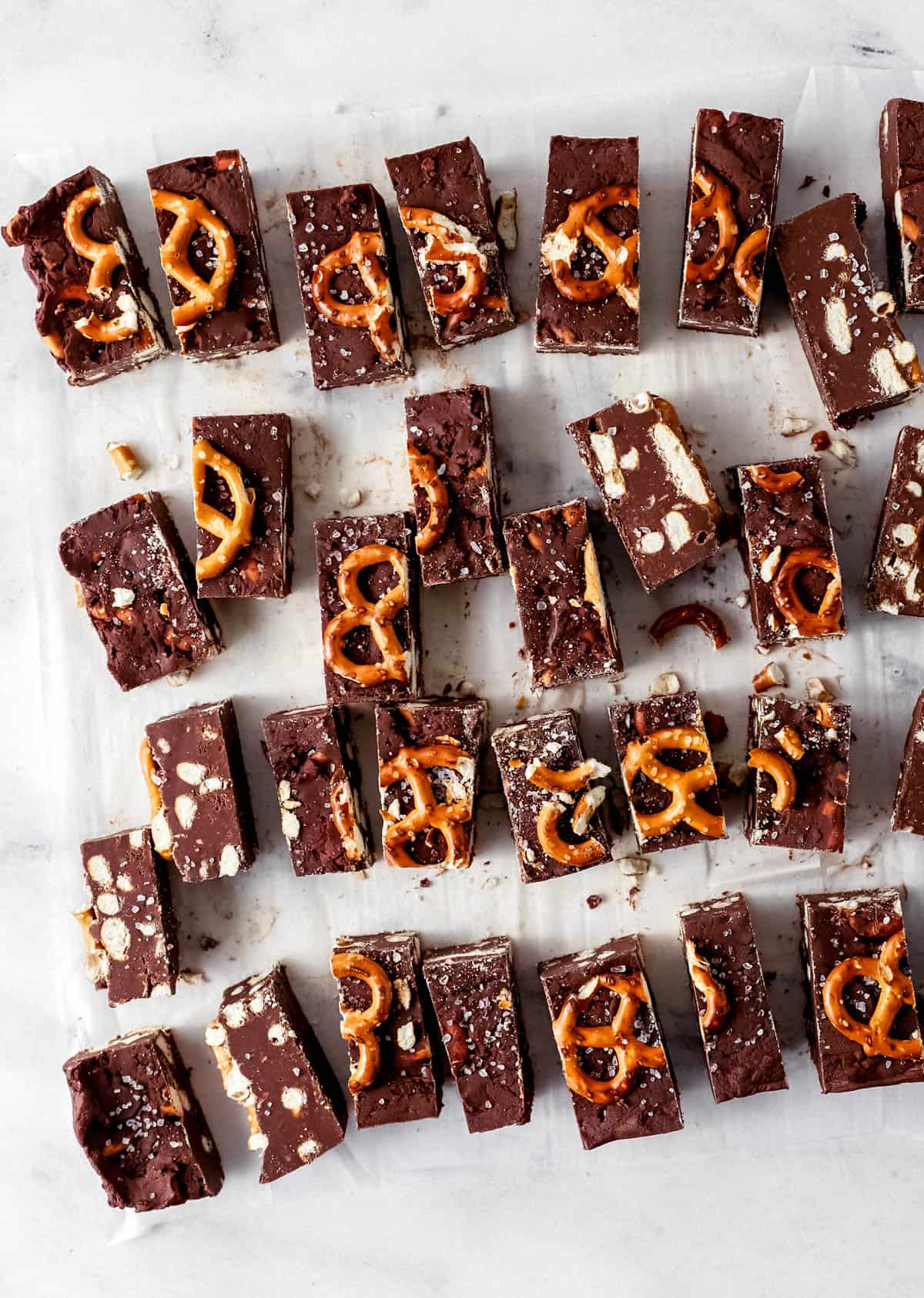 Overhead view of fudge cut in small pieces on parchment paper. 