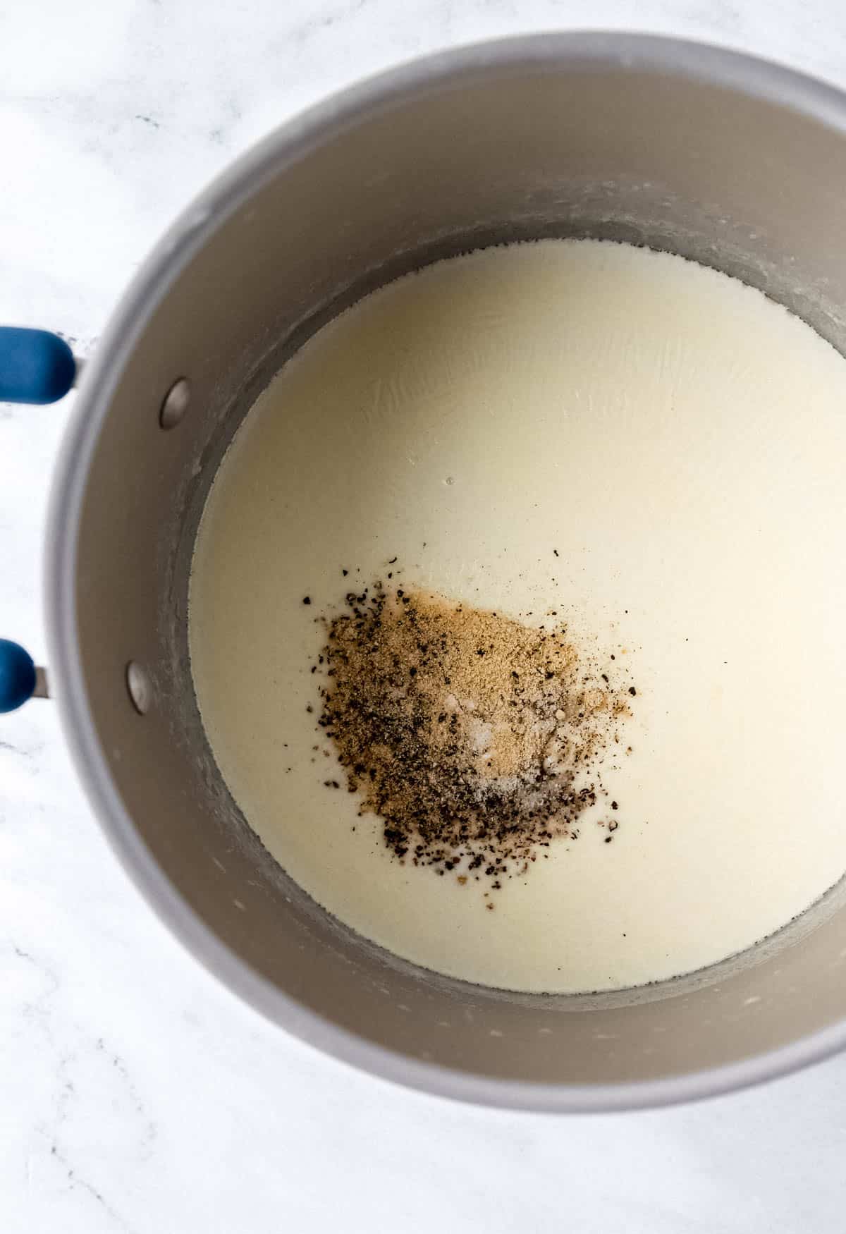 Overhead view of stockpot with seasonings added to the butter mixture. 