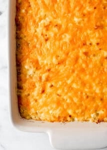 Overhead view of baked mac and cheese in white baking dish.