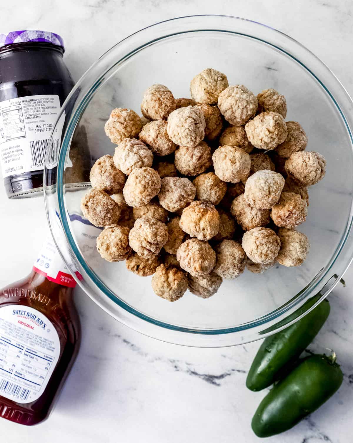 Overhead view of ingredients needed to make meatball in separate containers. 