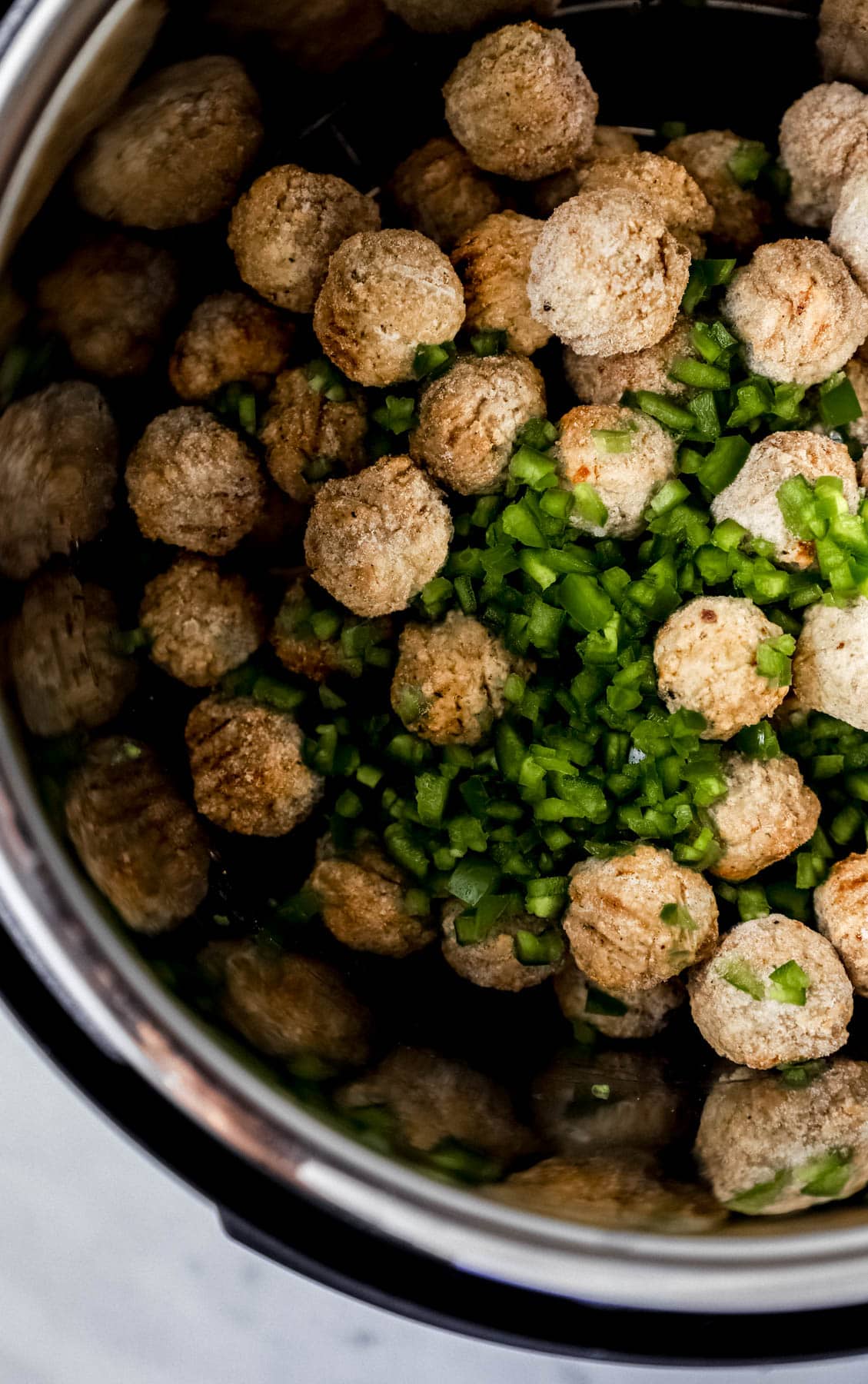 Frozen meatballs and diced jalapenos in pressure cooker.
