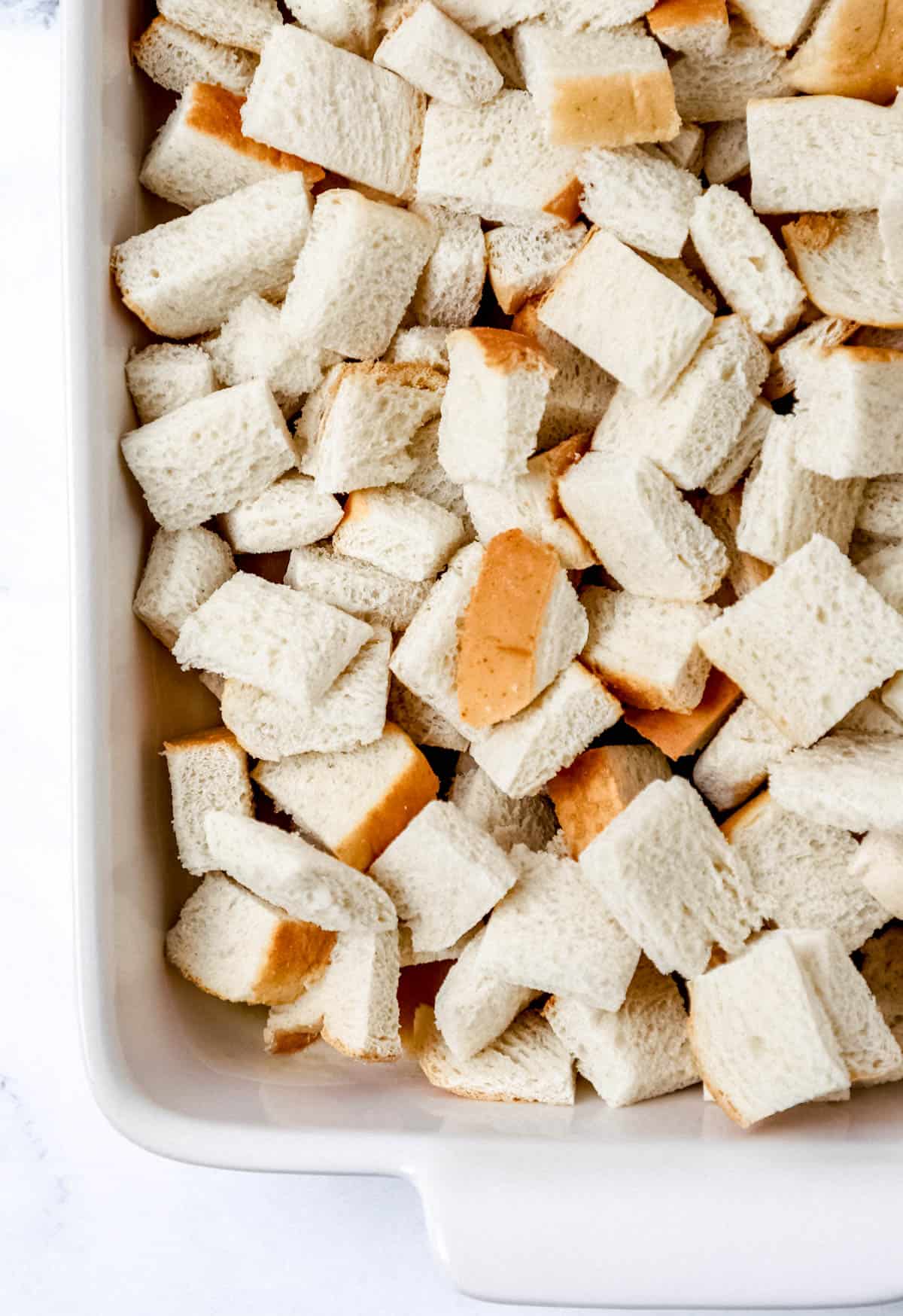 Cubed bread added to the baking dish on top of the brown sugar mixture. 