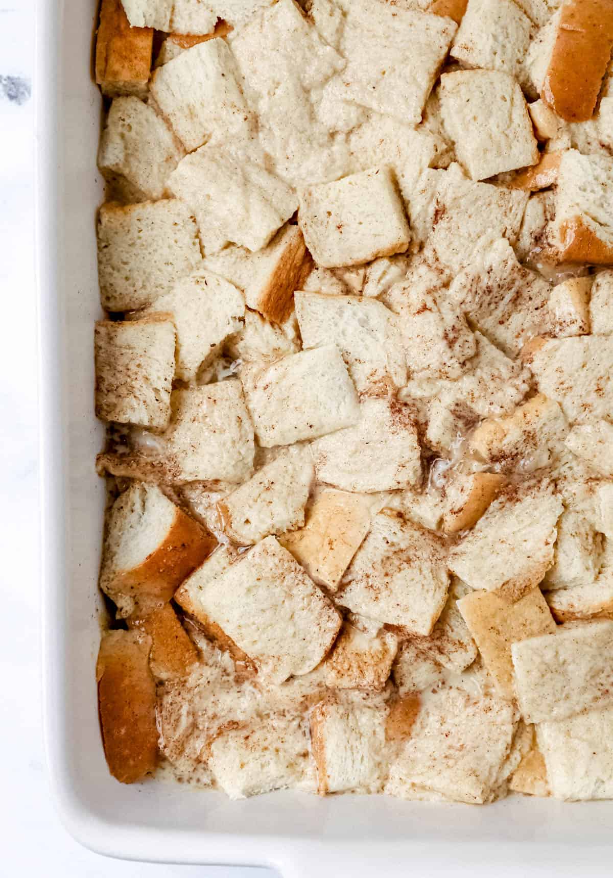 Overhead view of french toast in baking dish before covering to place into the refrigerator to chill. 