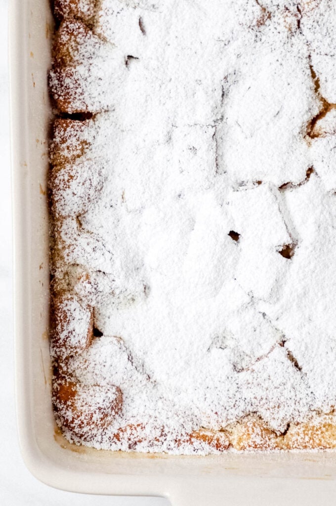 French toast in baking dish topped with powdered sugar.
