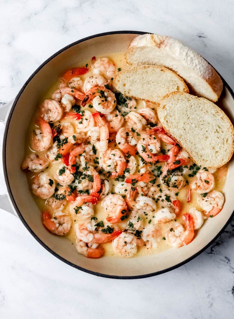 Overhead view of shrimp in pan with bread.