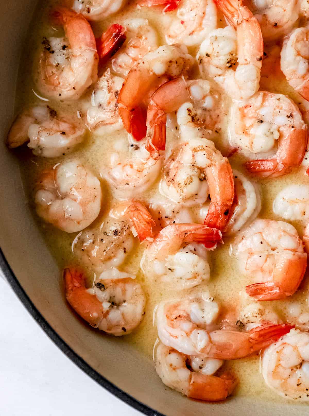 Chicken broth and lemon juice added to the braiser pan with the shrimp and other ingredients. 