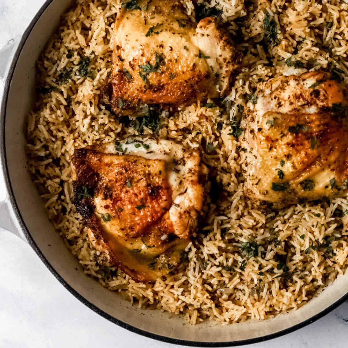 Overhead view of finished chicken and rice in pan.