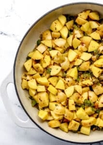 Potato added to the braiser with the cooked peppers and onion.