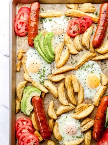 Close up overhead view of finished sheet pan breakfast bake with avocado and tomato added.