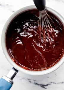 Chocolate dip in saucepan with whisk.