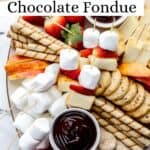 Overhead view of finished dessert board with chocolate fondue pin with text overlay.