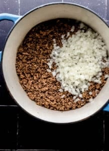 Ground beef and onion is a large stock pot.